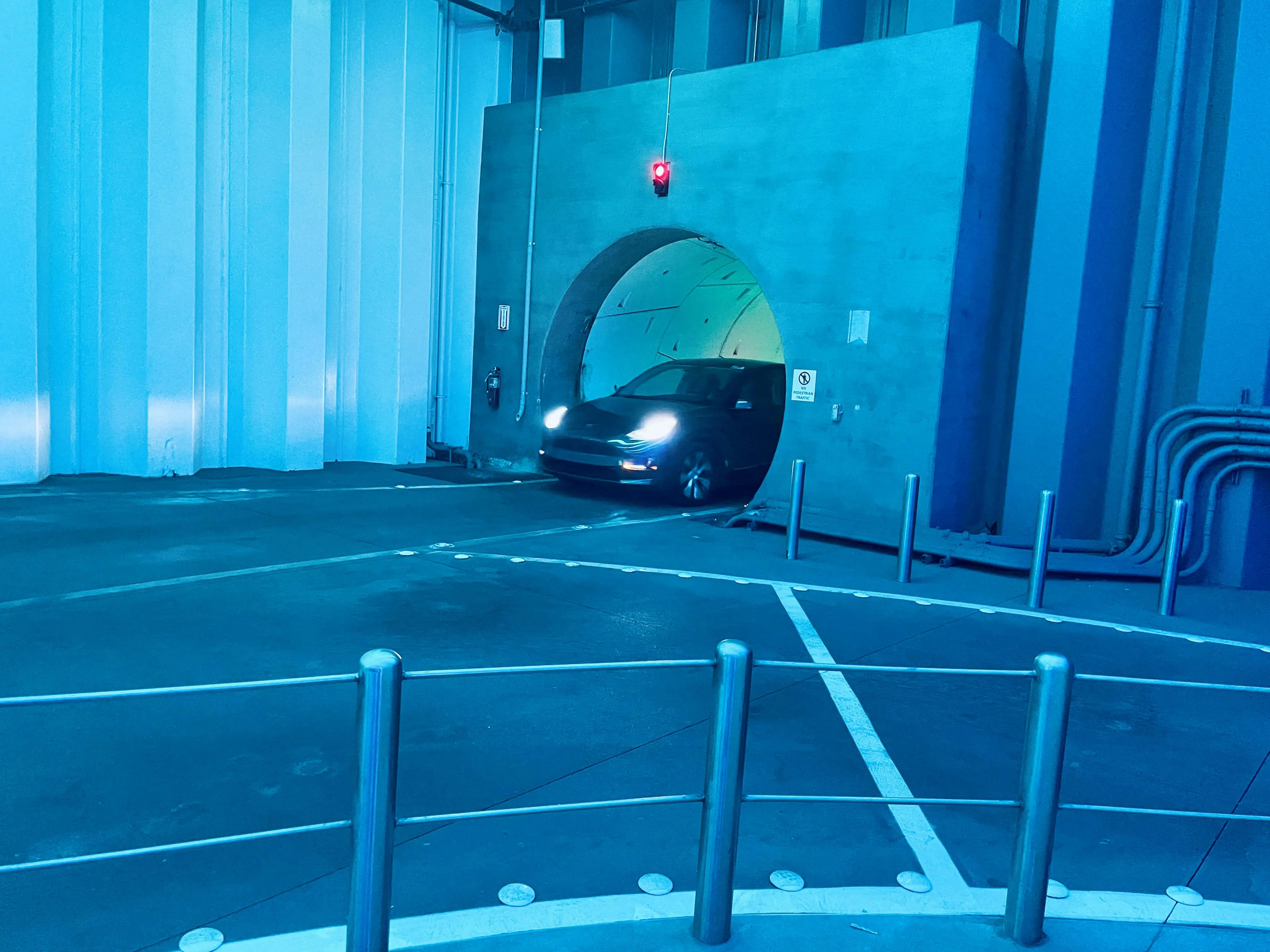 A car entering the underground Las Vegas Loop tunnel, used as a model for reducing attack surface by controlling entry and exit points.